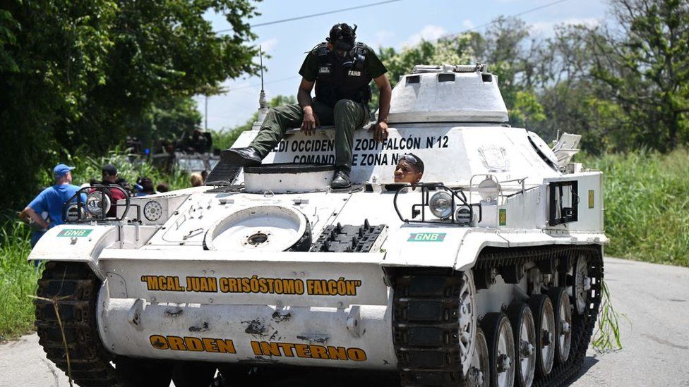 An armoured vehicle drives near the Tocoron prison after authorities seized control of the prison in Tocoron, Aragua State, Venezuela, on September 20, 2023.