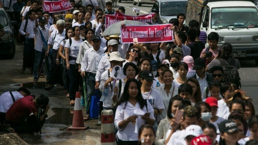 Protesters walk to the Central Investigation Department (CID) during the demonstration demanding justice for a two-year-old who was raped and given the pseudonym "Victoria" in Yangon on July 6, 2019.