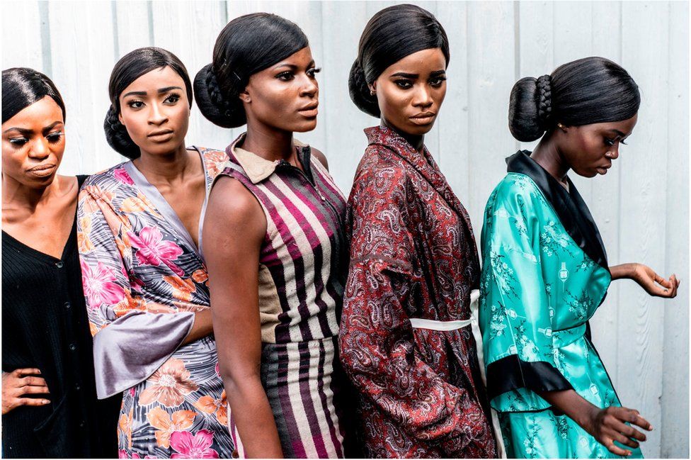 Models display their make up to stage managers and designers ahead of the final dressing up at the Africa Fashion Week in Lagos