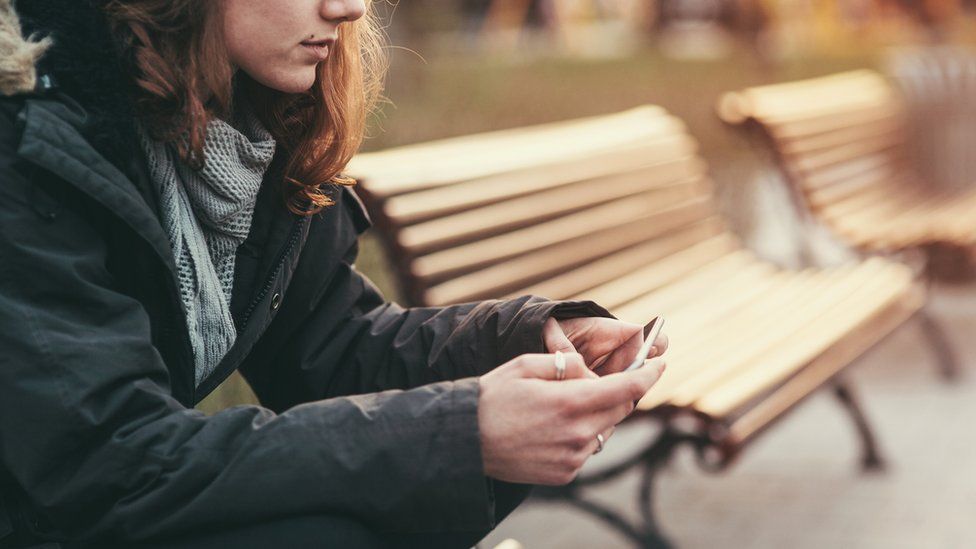 Girl sitting on bench (stock image)