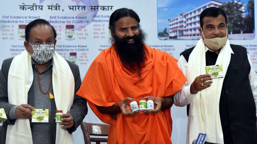 Union Ministers Nitin Gadkari and Dr. Harsh Vardhan, Swami Baba Ramdev releases evidence based Patanjali Covid-19 Medicine Coronil during a press conference on February 19, 2021 in New Delhi, India. In June last year, Patanjali had launched 'Coronil and Swasari', what it claims is the Ayurvedic cure for treating Covid-19. Coronil has received the Certificate of Pharmaceutical Product (CoPP) from the Ayush section of Central Drugs Standard Control Organisation as per the WHO certification scheme," said Patanjali in a statement. (Photo by Sonu Mehta/Hindustan Times via Getty Images)