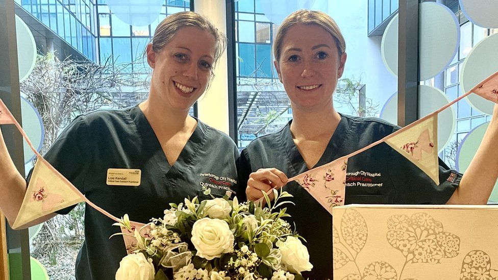 Two nursing practitioners with bunting and flowers