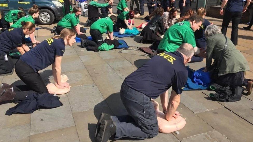 People learning CPR in Lincoln city centre