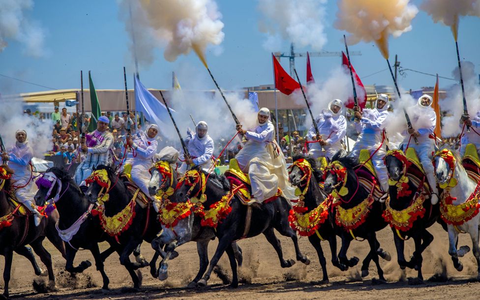 Traditional horse riders firing guns in a Tbourida in Bouznika, Morocco - Wednesday 10 May 2023