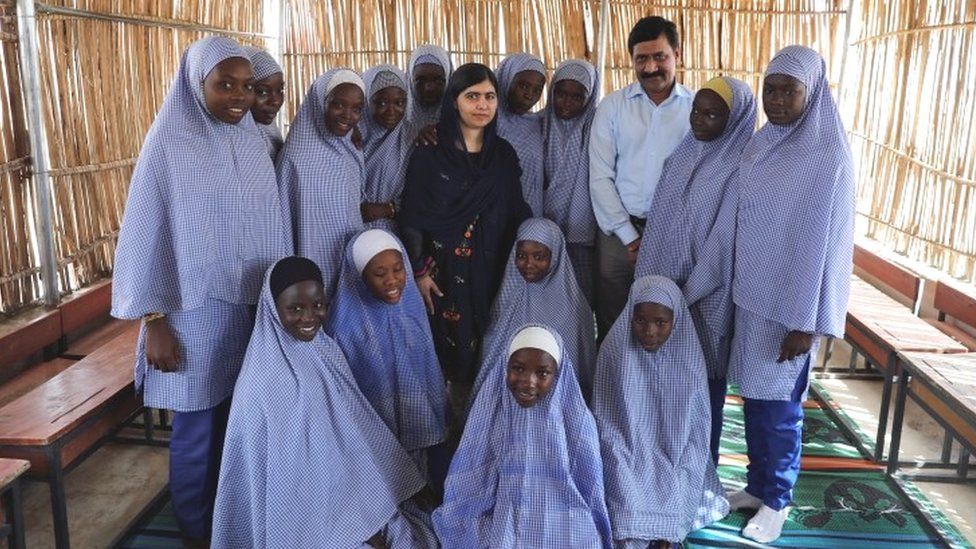 Nobel laureate Malala Yousafzai poses twith her father Ziauddin Yousafzai and students at the Unicef-funded school at Bakassi camp in Maiduguri, Nigeria July 18, 2017