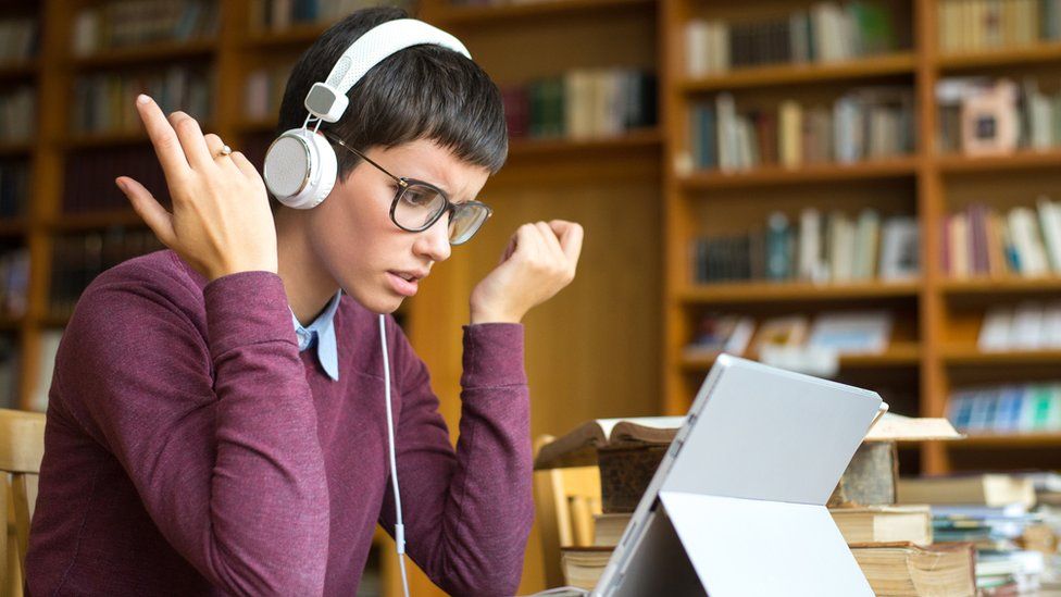 stock image of an annoyed woman wearing headphones