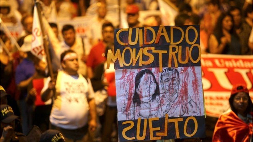 Peruvians participate during a demonstration with a sign that reads 'Watch out - loose monster' with a cartoon of ex-president Alberto Fujimori and his daughter Keiko Fujimori in Lima, Peru, 11 January 2018