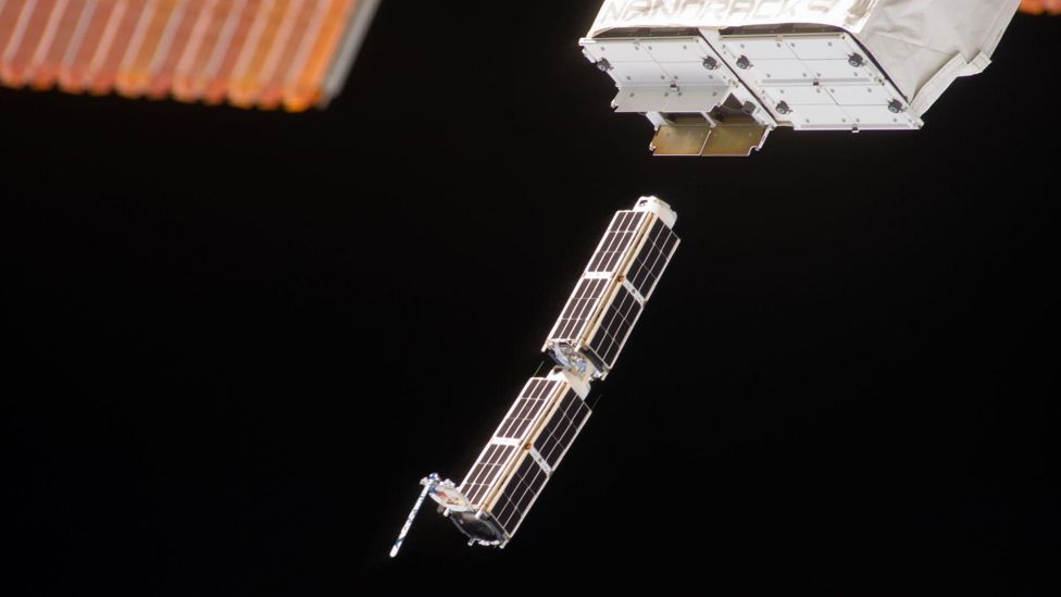 A set of NanoRacks CubeSats is deployed from the ISS
