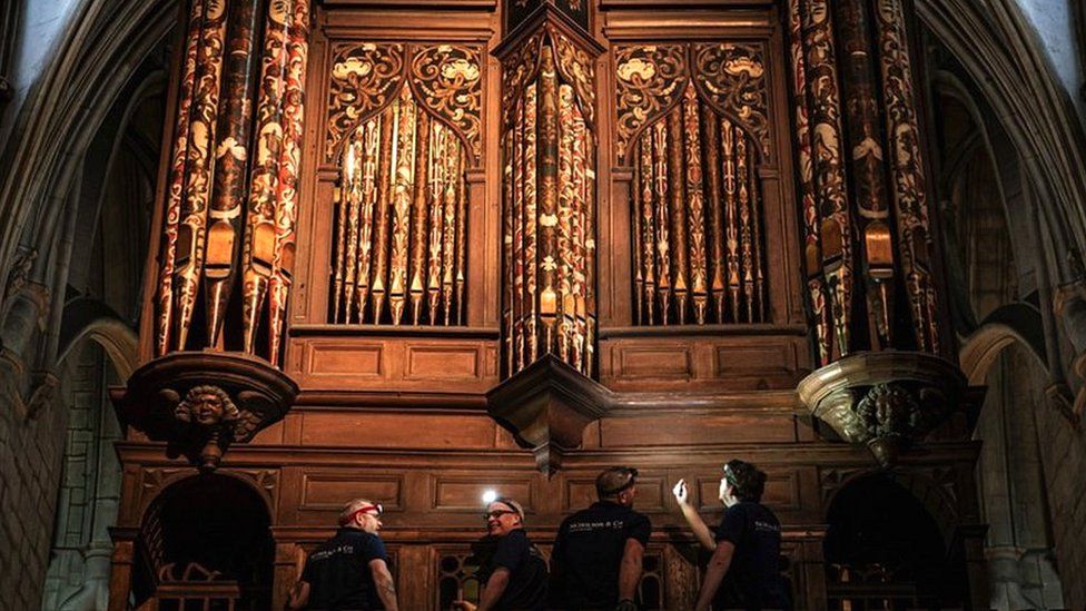 Image of four men working in the Cathedral.