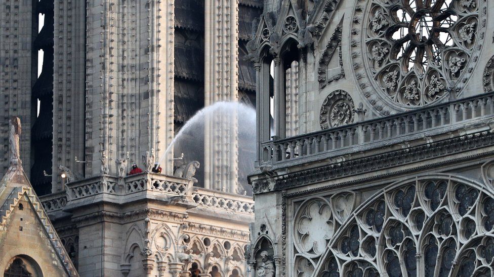 Firefighters hose down Notre-Dame cathedral after a fire tore through the ancient building, April 2019