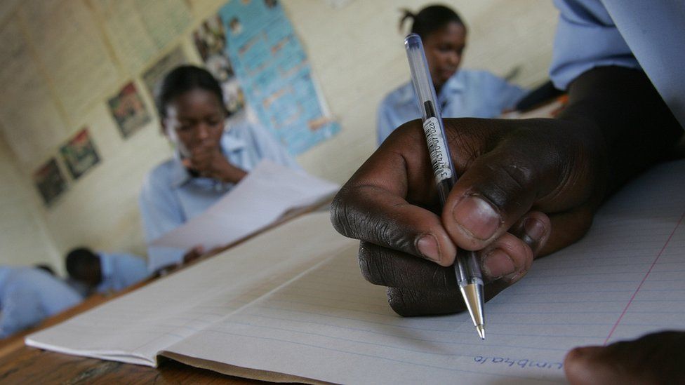 Pupil writing in a book