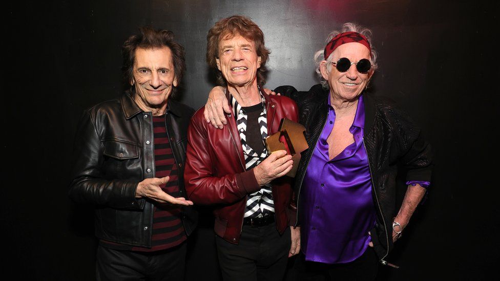 Ronnie Wood, Mick Jagger and Keith Richards celebrating their recent success