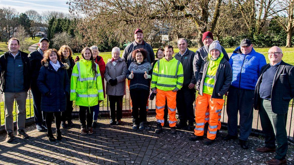 A volunteer group of people from Friends of Kingswood Park gathered smiling at the camera