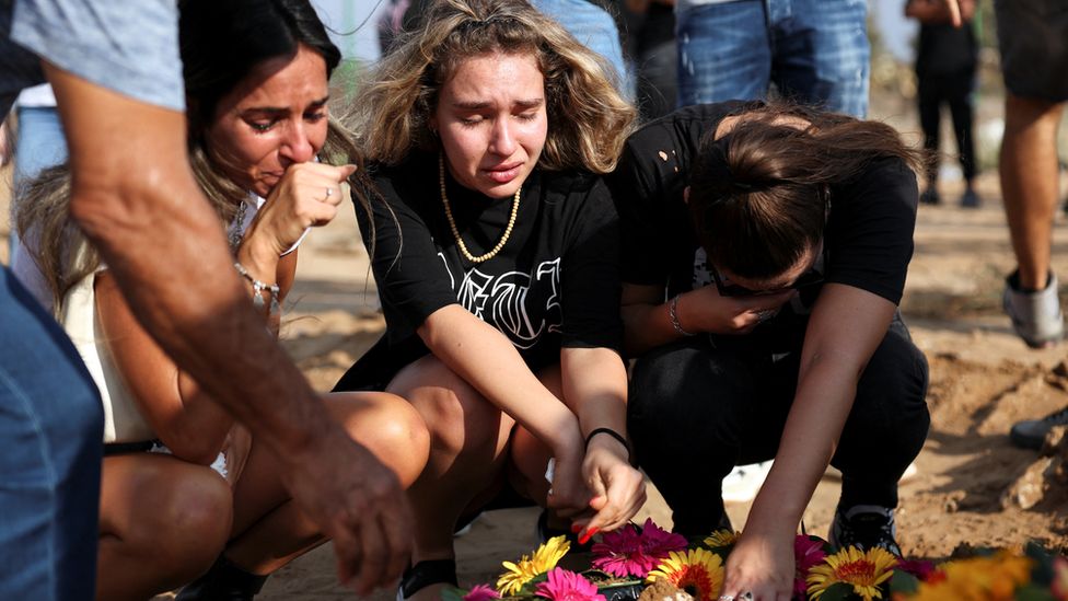 People mourn at the graveside of a person killed during Hamas attacks on Israel