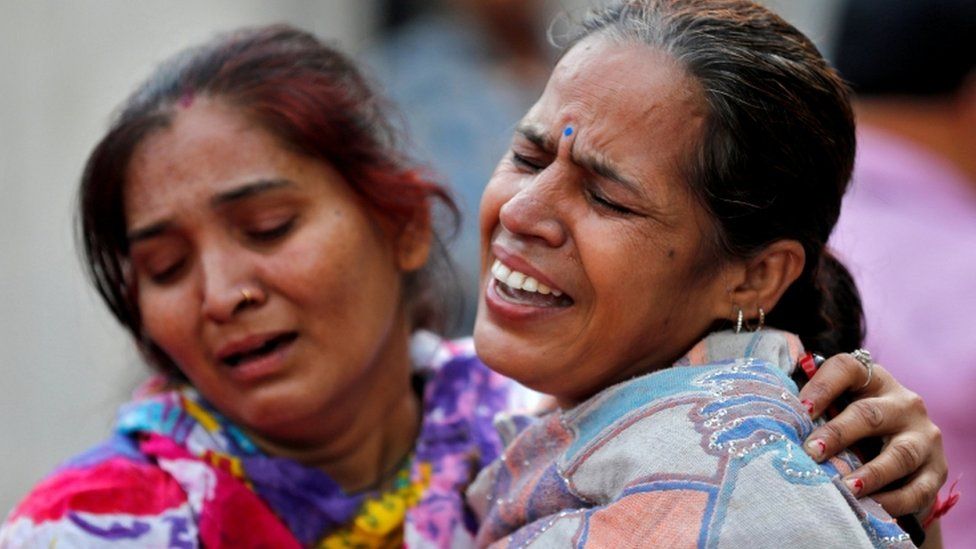 Two women cry outside an Armritsar hospital