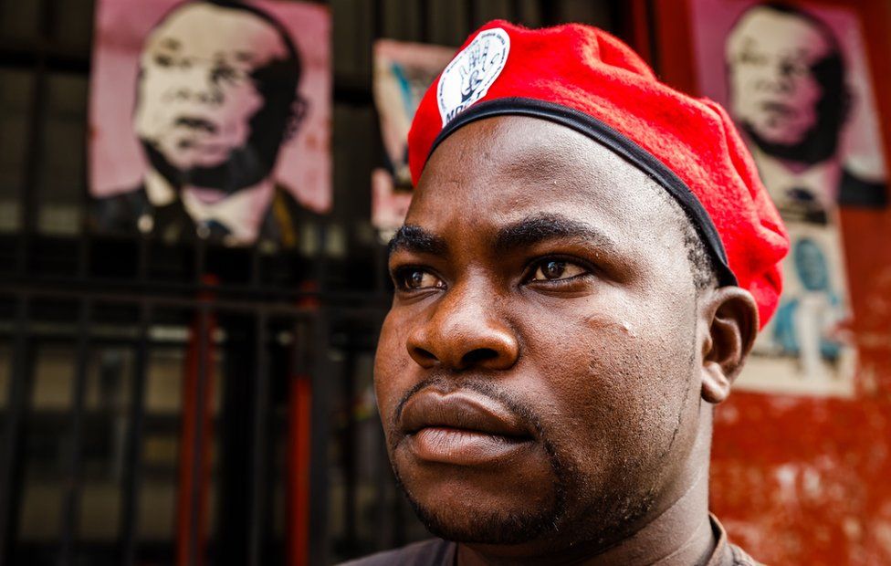 A member of Zimbabwe's opposition party "Movement for Democratic Change" (MDC) stands outside Harvest House, the party's headquarters, in Harare on 15 February 15, 2018.