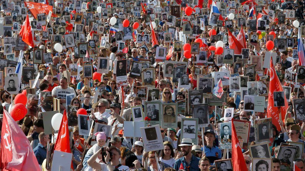 People hold pictures of World War Two soldiers as they take part in the Immortal Regiment march during the Victory Day celebrations, marking the 71st anniversary of the victory over Nazi Germany in World War Two, in central Moscow, Russia, May 9, 2016