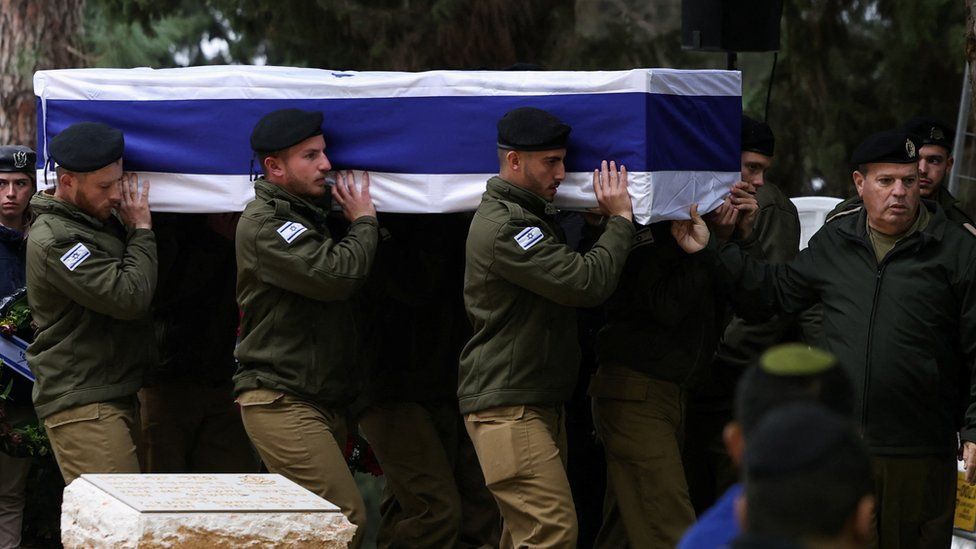 Israeli soldiers carry the casket at the funeral of one reservist killed in Monday's attack