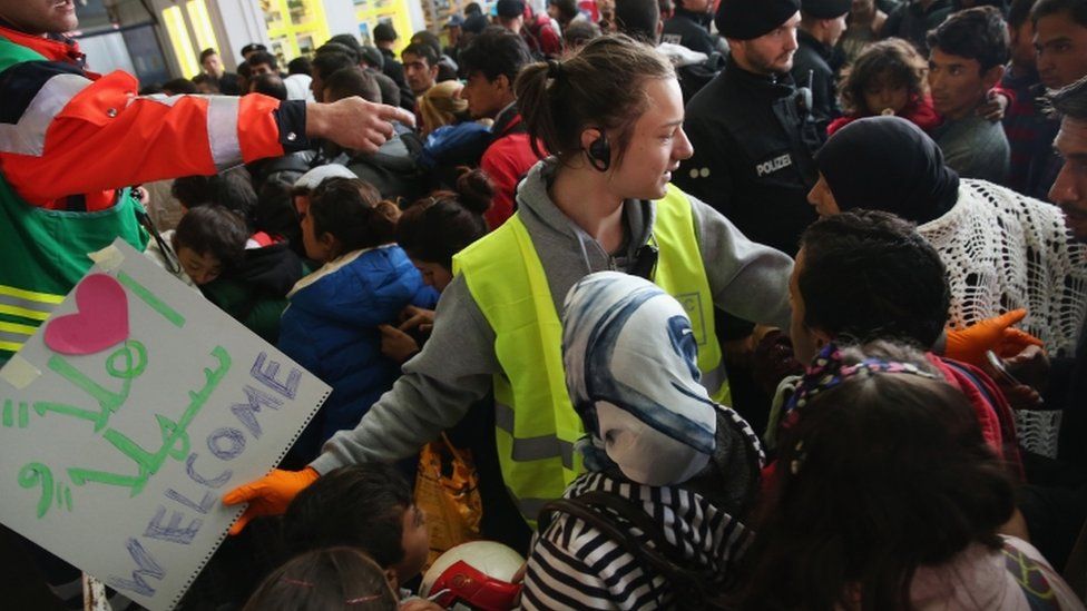 Migrants arriving from Hungary crowd into a holding space at Munich main railway station, 6 September