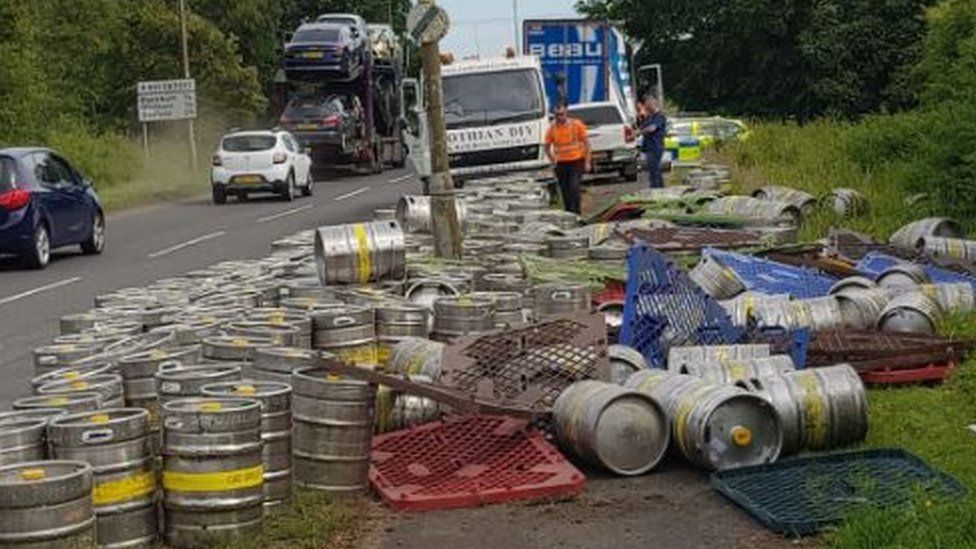 Thirsty work as police clear spilled beer kegs from road in West(00)