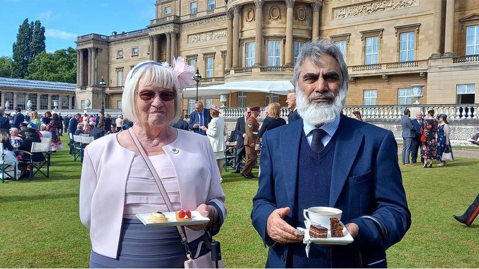 Luton Council of Faiths Chair Prof Zafar Khan (R) and Vice Chair Gulie Butcher at the Royal Garden Party 2022, after receiving the Queen's Award for Voluntary Services in 2021