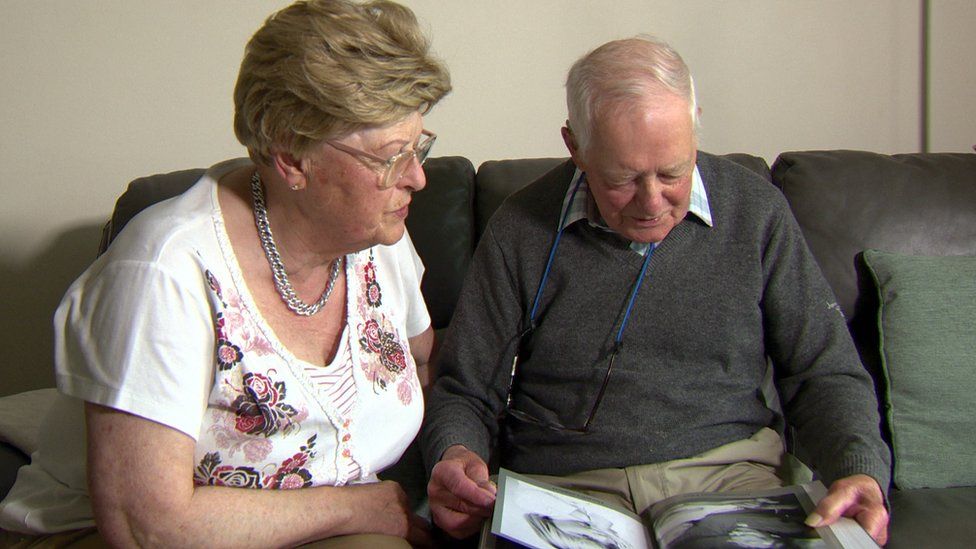 Miriam and Ian looking at a photo album together