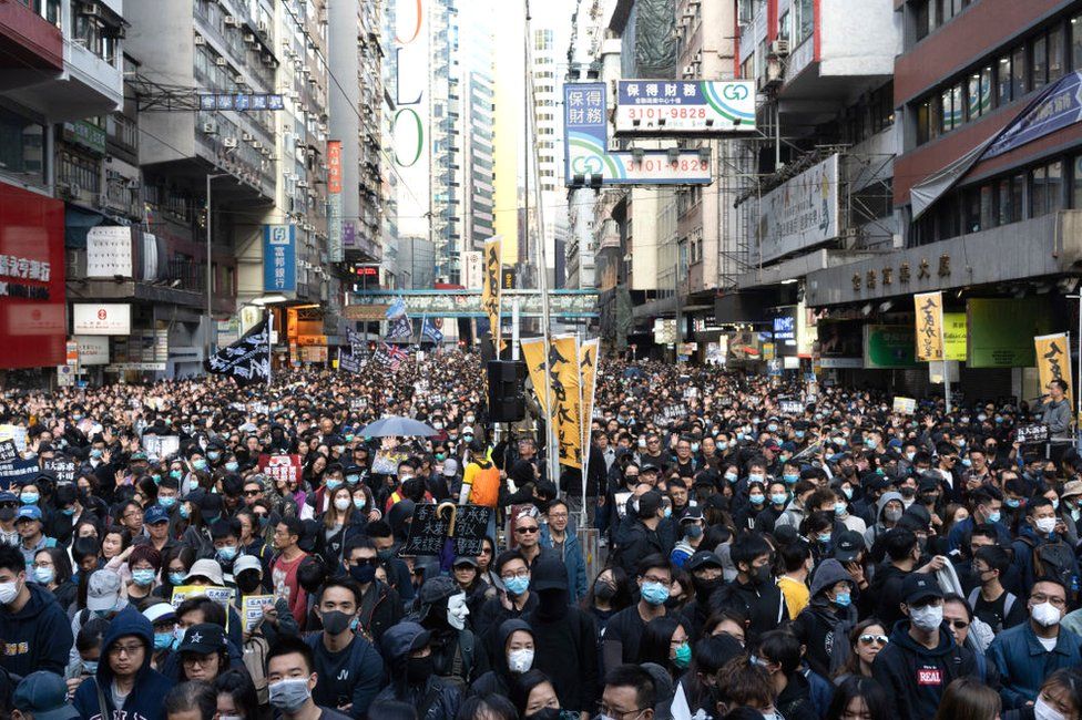 Pro-democracy protesters march on a street as they take part in a demonstration on December 8, 2019 in Hong Kong, China.
