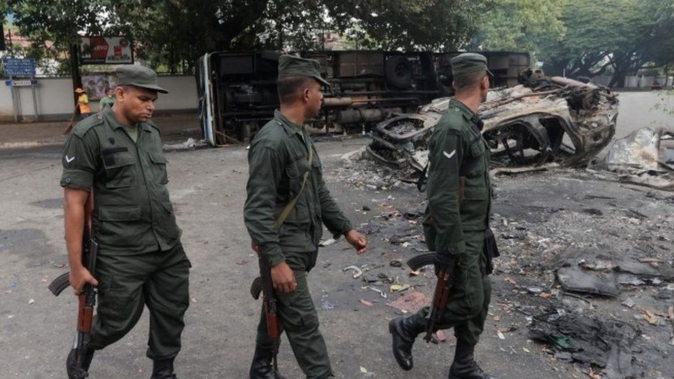 Troops near burned out vehicles