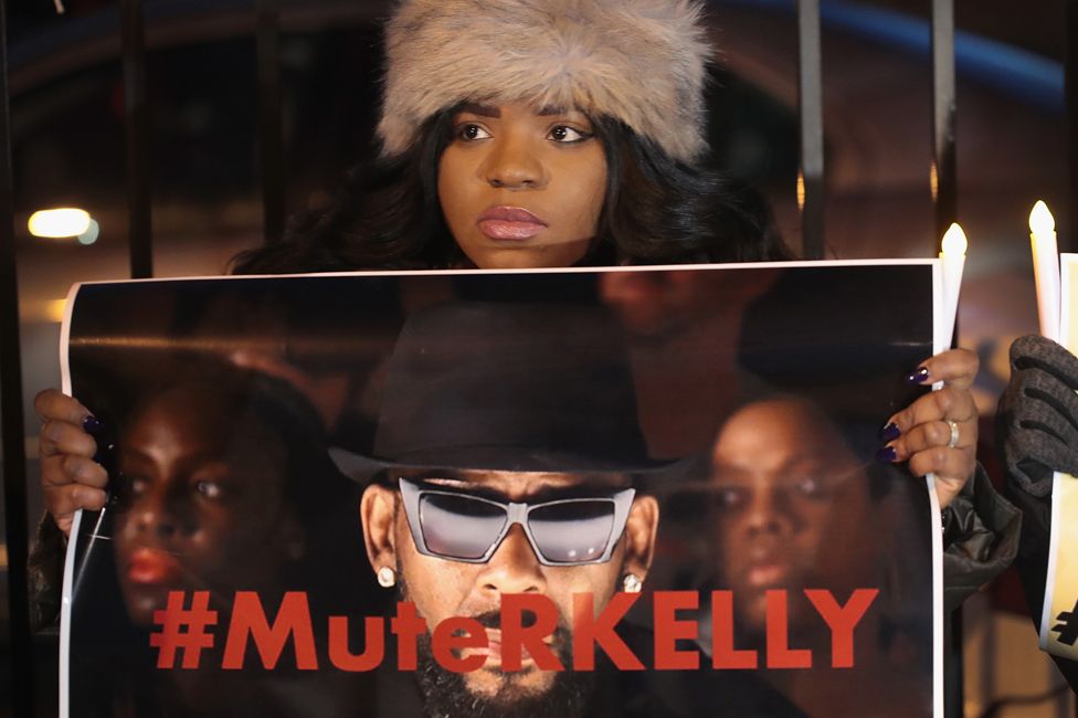 A protester calls for Spotify and radio stations to mute R Kelly