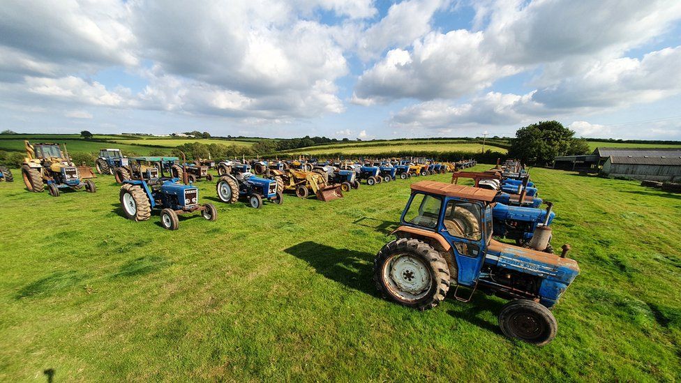 Tractors lined up in field