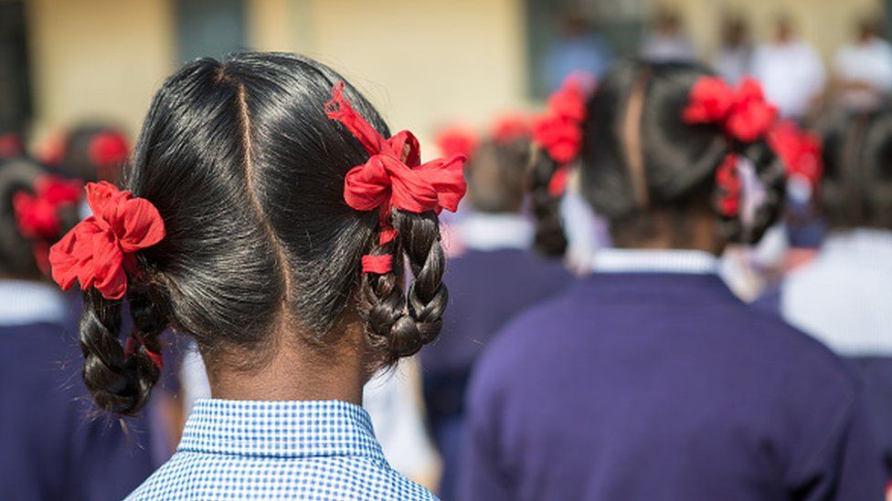 An schoolgirl in India pictured from behind