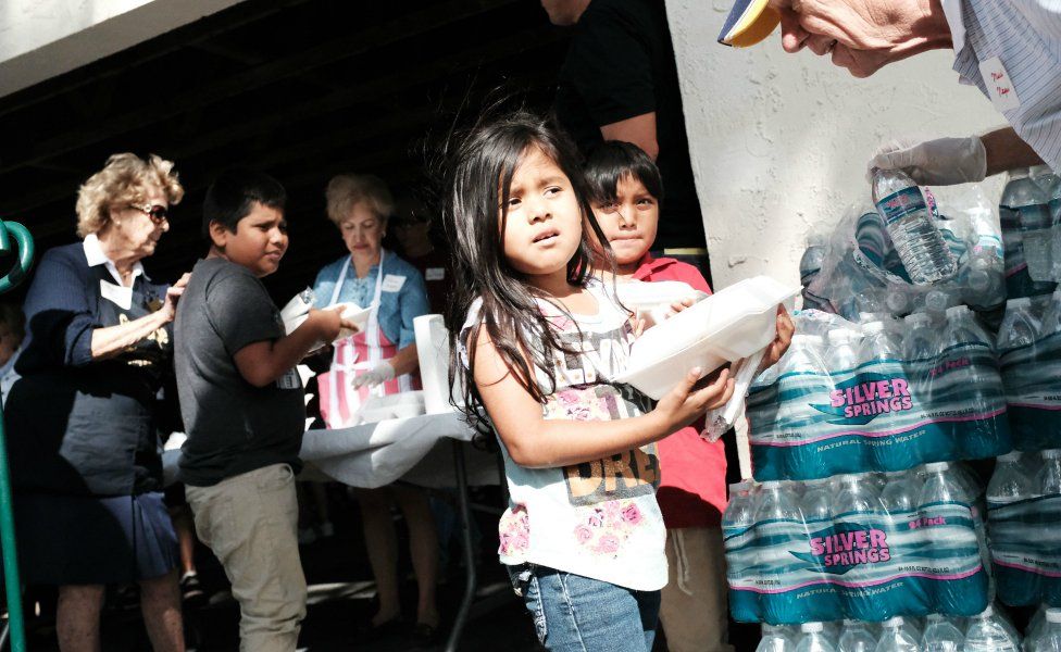 Children receive food at the annual Thanksgiving in the Park gathering where residents of the farm worker community of Immokalee are provided with a free Thanksgiving meal on November 22, 2018 in Immokalee, Florida