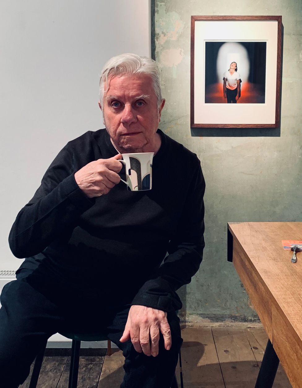 Photographer Brian Griffin drinking from a mug