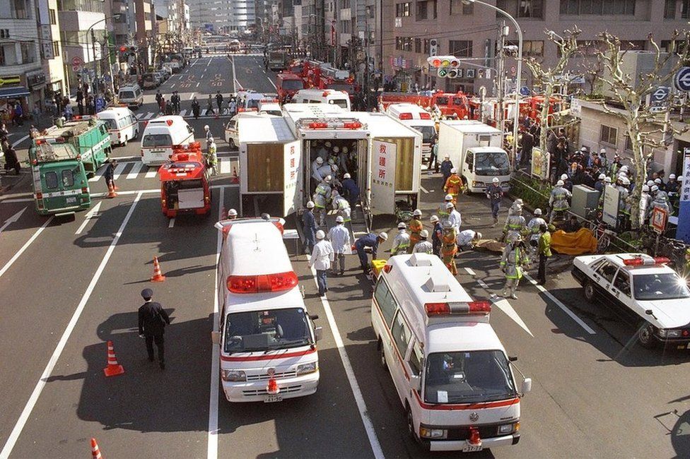 Rescue workers carry the survivors to the emergency rescue tents at Tokyo Metro Tsukiji Station on March 20, 1995 in Tokyo.