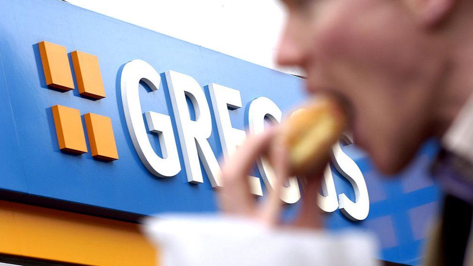 Man eating a pasty from Greggs