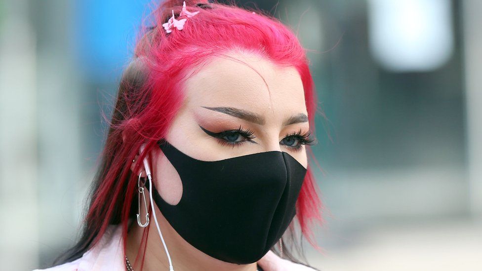 A woman in Belfast wearing a mask