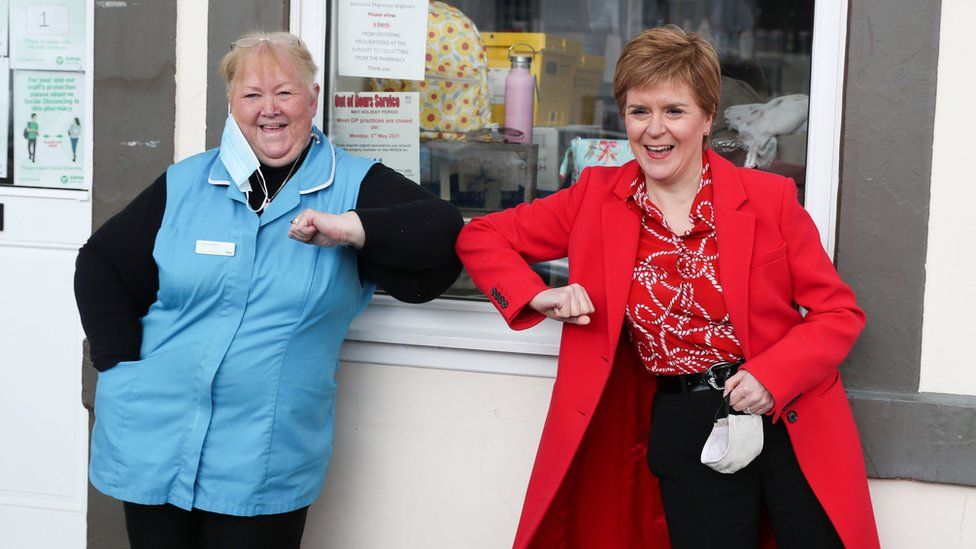 SNP leader Nicola Sturgeon bumps elbows with a woman in Wigtown