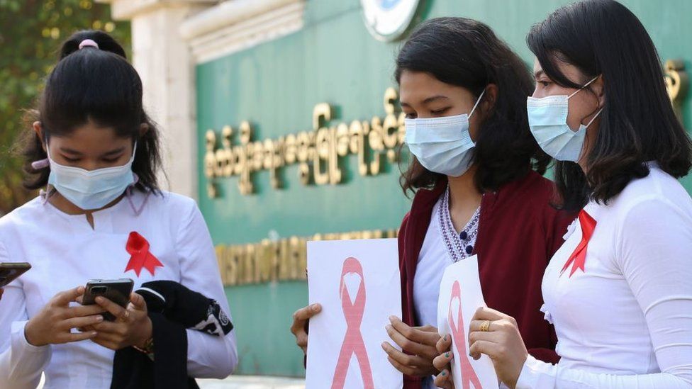 Myanmar department of agriculture workers in the capital wear red ribbons in protest against the coup, 4 February