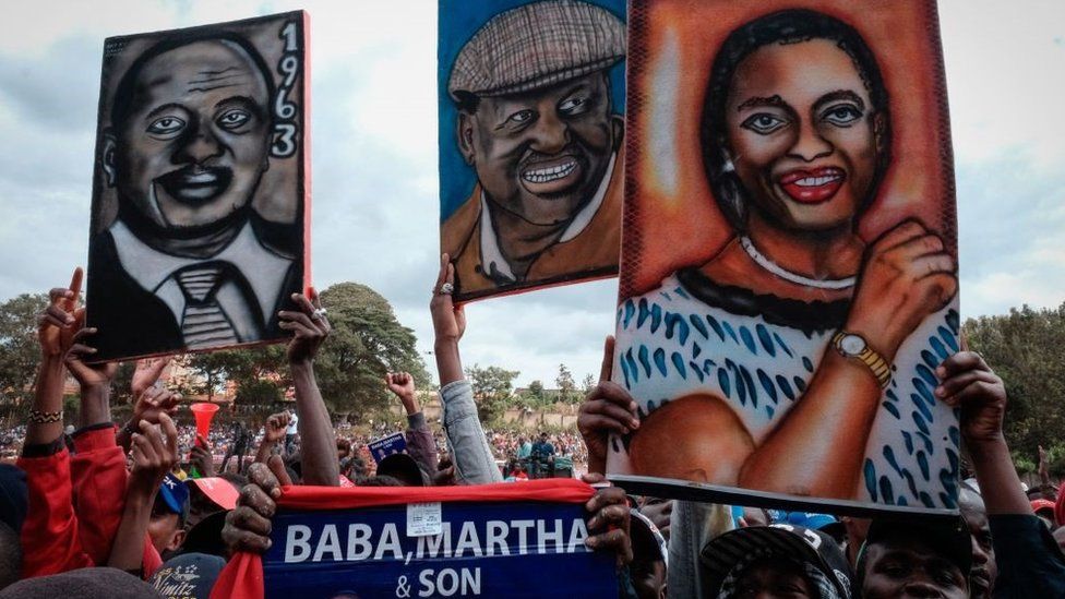 Supporters hold painted portraits of Kenya's President Uhuru Kenyatta (L), Azimio La Umoja Coalition presidential candidate Raila Odinga (C) and running mate Martha Karua during a campaign rally in Murang'a on July 23, 2022, ahead of Kenya's August 2022 general election
