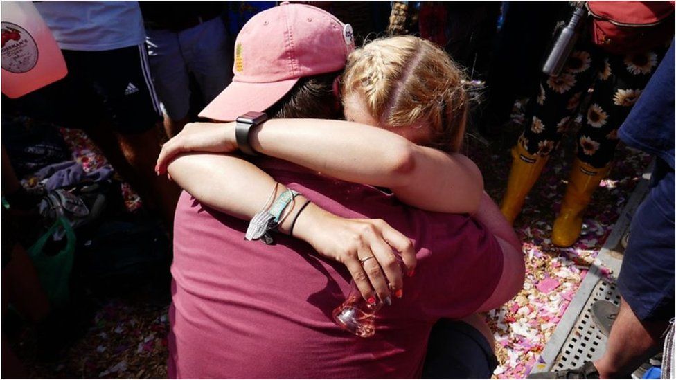 Newly-engaged couple hug at Glastonbury