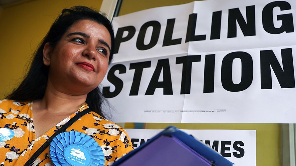 A Conservative Party canvasser stands outside a polling station on the day of the by-election for Britain's parliamentary constituency of Uxbridge, in Uxbridge, west London, Britain, 20 July 2023
