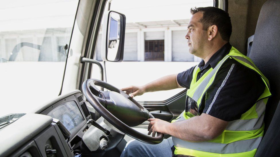 Lorry driver leaving a warehouse.