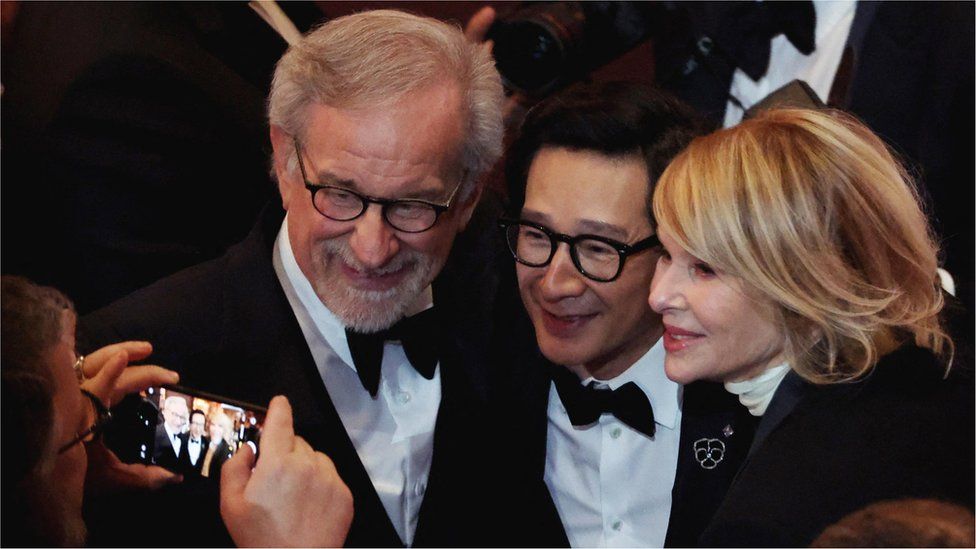 Ke Huy Quan, Kate Capshaw and Steven Spielberg gesture at the Oscars show at the 95th Academy Awards in Hollywood, Los Angeles, California, U.S., March 12, 2023