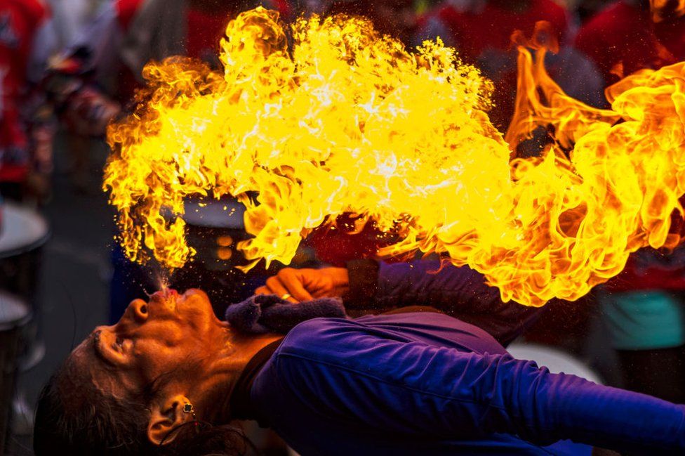 A performer breathes fire during Lunar New Year celebrations in Manila, Philippines