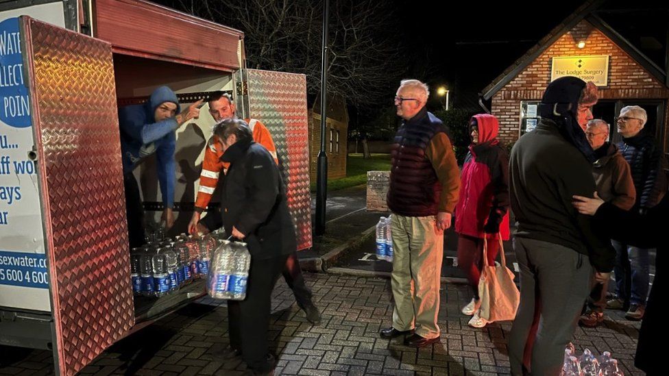 People collecting bottled water at Pewsham Community Centre