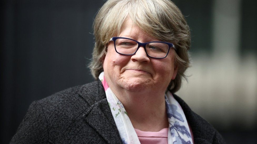 Therese Coffey walks outside Downing Street in London