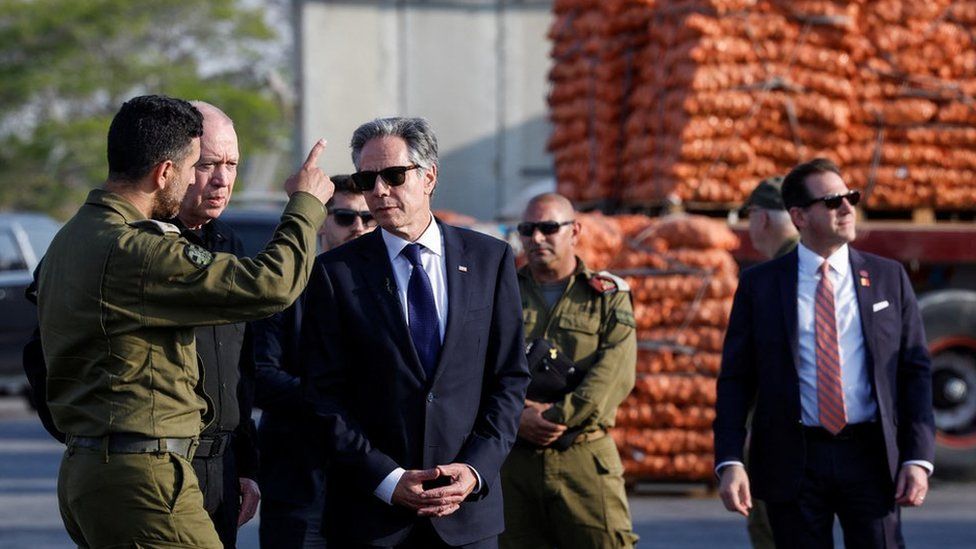 U.S. Secretary of State Antony Blinken walks with Israeli Defense Minister Yoav Gallant, at the Kerem Shalom border crossing, Israel