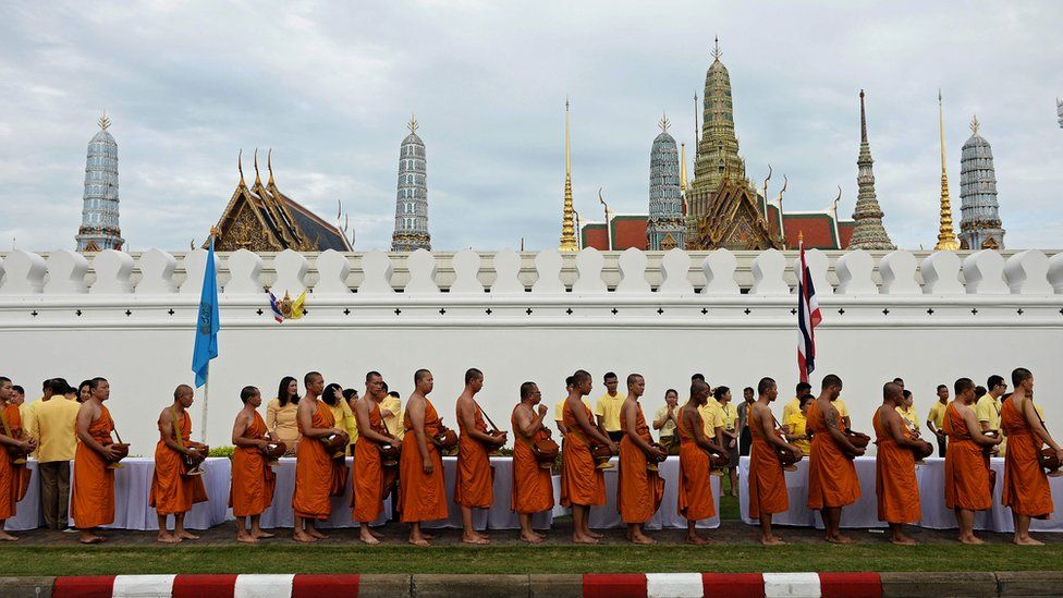 Buddhist monks walk towards The Grand Palace during the commemoration of the 70th anniversary of Thailand's King Bhumibol Adulyadej's reign in Bangkok on June 9, 2016.