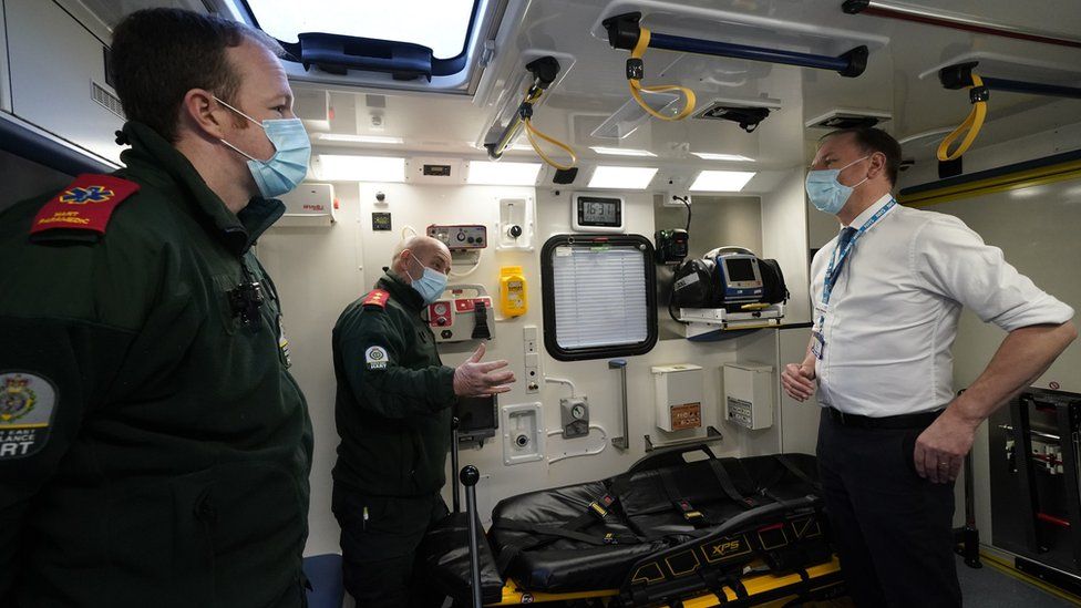 Andrew Staley and Mick Hulme inside an ambulance with Sir Simon Stevens
