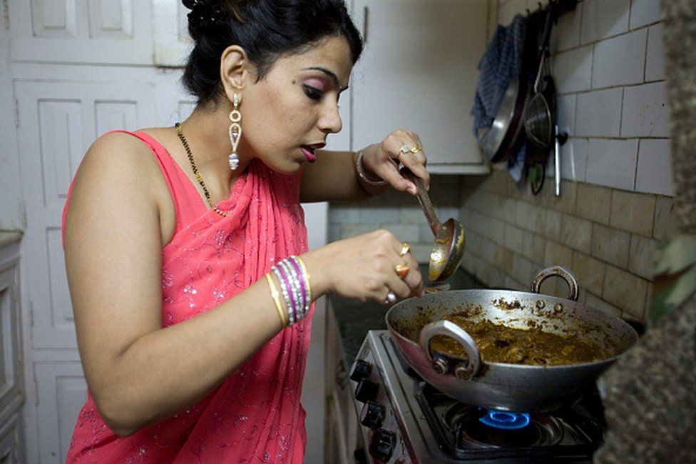 An Indian housewife at home in New Delhi cooks her favourite dish in her kitchen